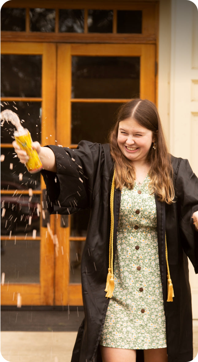 Isabelle Hale smiling and shaking an open can of Guayaki Yerba Mate.